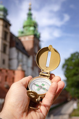 Visit to Kraków / Poland. compas showing the way to the most important monuments in the city /...
