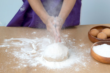 hand clipping white flour on table