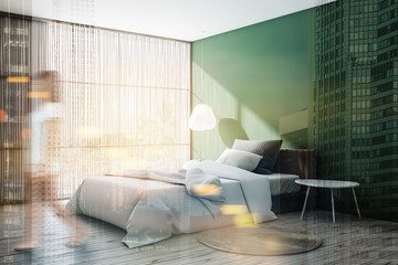 Woman walking in green bedroom with blinds