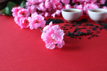 Fototapeta na wymiar Chinese tea ceremony with the use of utensils of clay on the background of the cherry blossom.
