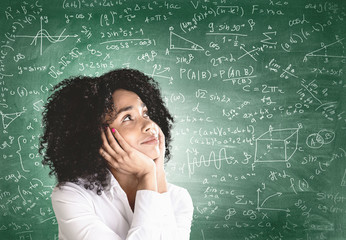 Thoughtful young African woman, math formula