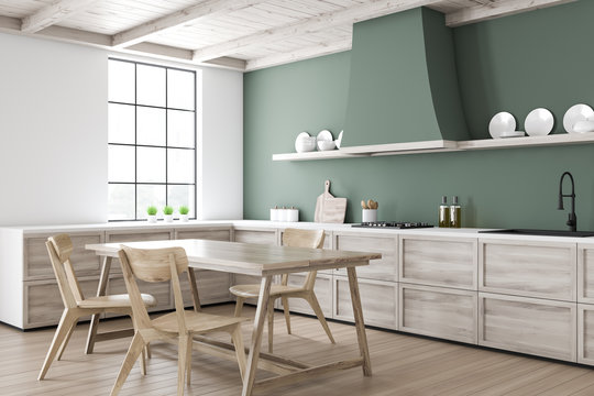 Green kitchen corner with dining table