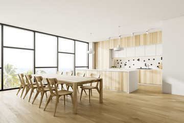 Corner of wooden kitchen with table and island