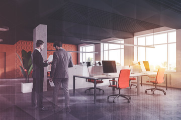 Two businessmen in orange open space office