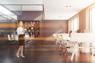 Blonde woman near gray meeting room
