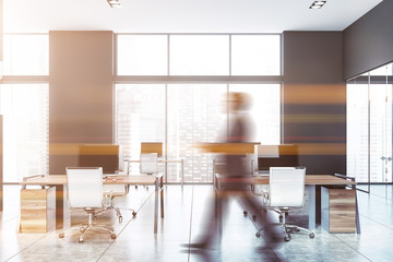 Man walking in modern gray open space office