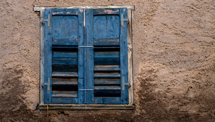 Fototapeta na wymiar View of a old house exterior and old vintage window with wooden shutters. Seen on a Venice street.