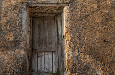 View of a old house exterior and old vintage wooden door. Seen on a Venice street.