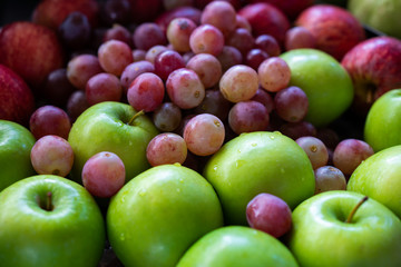 Fresh apple and grapes heap on the table, Dieting at healthy concept.