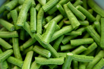 Fresh long bean cut into pieces in the bowl to prepare for cooking for vegetarian healthy food.