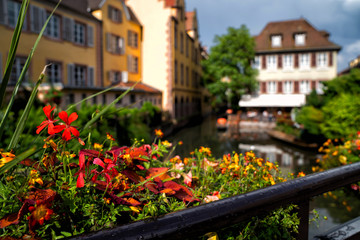 Fototapeta na wymiar View of the historic town of Colmar, also known as Little Venice, with tourists taking a boat ride along traditional colorful houses on idyllic river Lauch, Colmar, Alsace, France