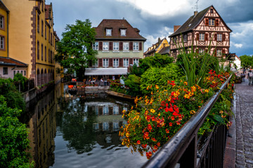 Fototapeta na wymiar Cityscaspe view on the old town with beautiful half-timbered houses and crowded streets in Colmar, famous french town in Alsace region.