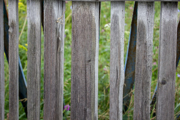 Fence of old wooden boards in the village