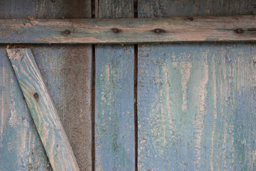 Old boards with peeling blue paint