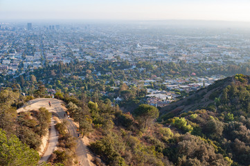 Overlooking walking  trail on Griffith park ,city of Los Angeles in the background on a hazy sunny day