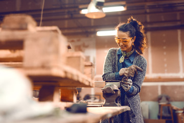 Girl working on clamp with protective glasses on.
