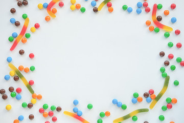 the concept of Halloween . orange pumpkin, colored sweets, candies