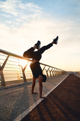 Fototapeta premium Young man doing exercise early in the morning on a pathway