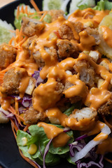 Salad and cheese dressing on table