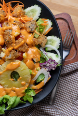 Salad and cheese dressing on table