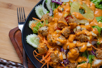 Salad and cheese dressing on table