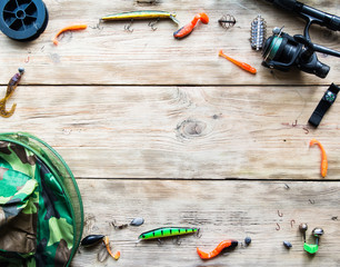 fishing tackle on a light old wooden background © FytyaKarman