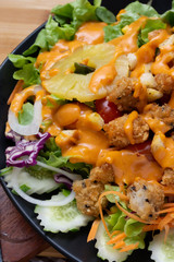 Salad and cheese dressing on table