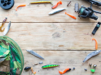 fishing tackle on a light old wooden background © FytyaKarman