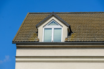 Exterior of a penthouse in summer against a blue sky