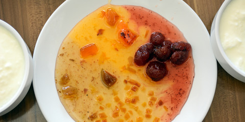 Jam in a white plate. Near yogurt in white cups. Concept - Breakfast