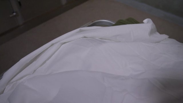 Scene in a modern morgue - body on gurney