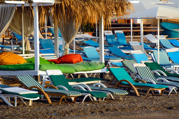 Empty beach in the morning. Sunbeds, thatched sheds. Concept - Beach Vacation