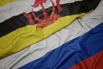 waving colorful flag of russia and national flag of brunei.