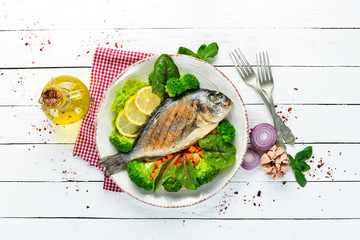 Dorado fish with grilled vegetables. Seafood. Top view. Free copy space.