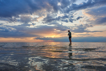 husband at sea watching the sunset