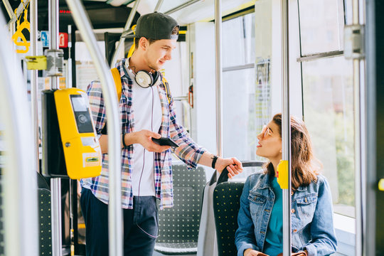 Young Millennial Couple, Man And Woman In Modern Tram Interior.