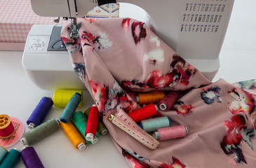 Sewing machine, fabric cotton and colorful threads for sewing.Sewing accessories