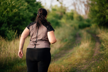 Cropped portrait of overweight runner go jogging outdoors. Weight loss, sports, healthy lifestyle
