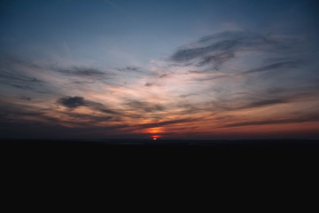 Beautiful sunset over a dark landscape. Dramatic sunset
