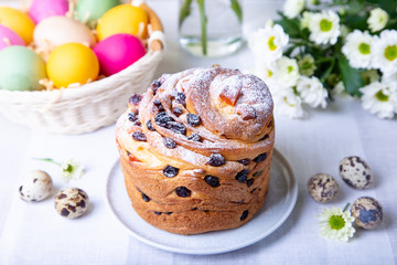 Craffin (Cruffin) with raisins and candied fruits. Easter Bread Kulich and painted eggs. Easter Holiday. Close-up.