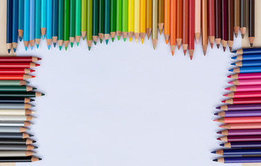 Fototapeta premium Green colored pencils on white background with copy space.. Back to school