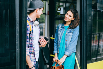 Happy young couple spending time at the cafe indoors, listening to music with headphones