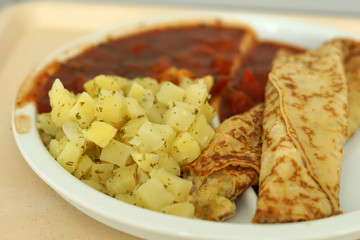 Crepes with tomato ragout as a delicious dinner in a hospital