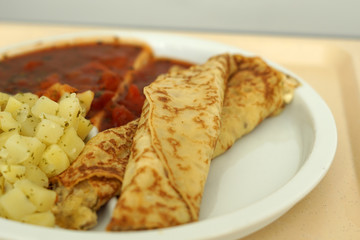 Crepes with tomato ragout as a delicious dinner in a hospital