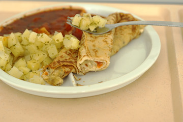 Crepes with tomato ragout as a delicious dinner in a hospital