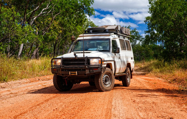 Obraz na płótnie Canvas Western Australia – Outback track with 4WD car at the at the savanna