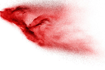 Abstract red dust splattered on white background. Red powder explosion.Freeze motion of red...