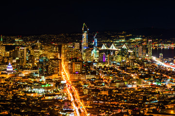 Night pnoramic view of San Francisco downtown with skyscrapers and Okeland Bridge