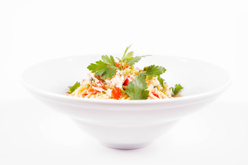 Spaghetti with cream sauce with smoked mackerel, peas ,bell pepper and some parsley on a white plate on a white background