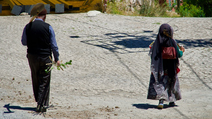 Old husband and wife going to work in their village